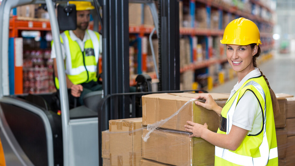Warehouse employees unloading packages